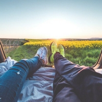 Man and woman relaxing in a field.