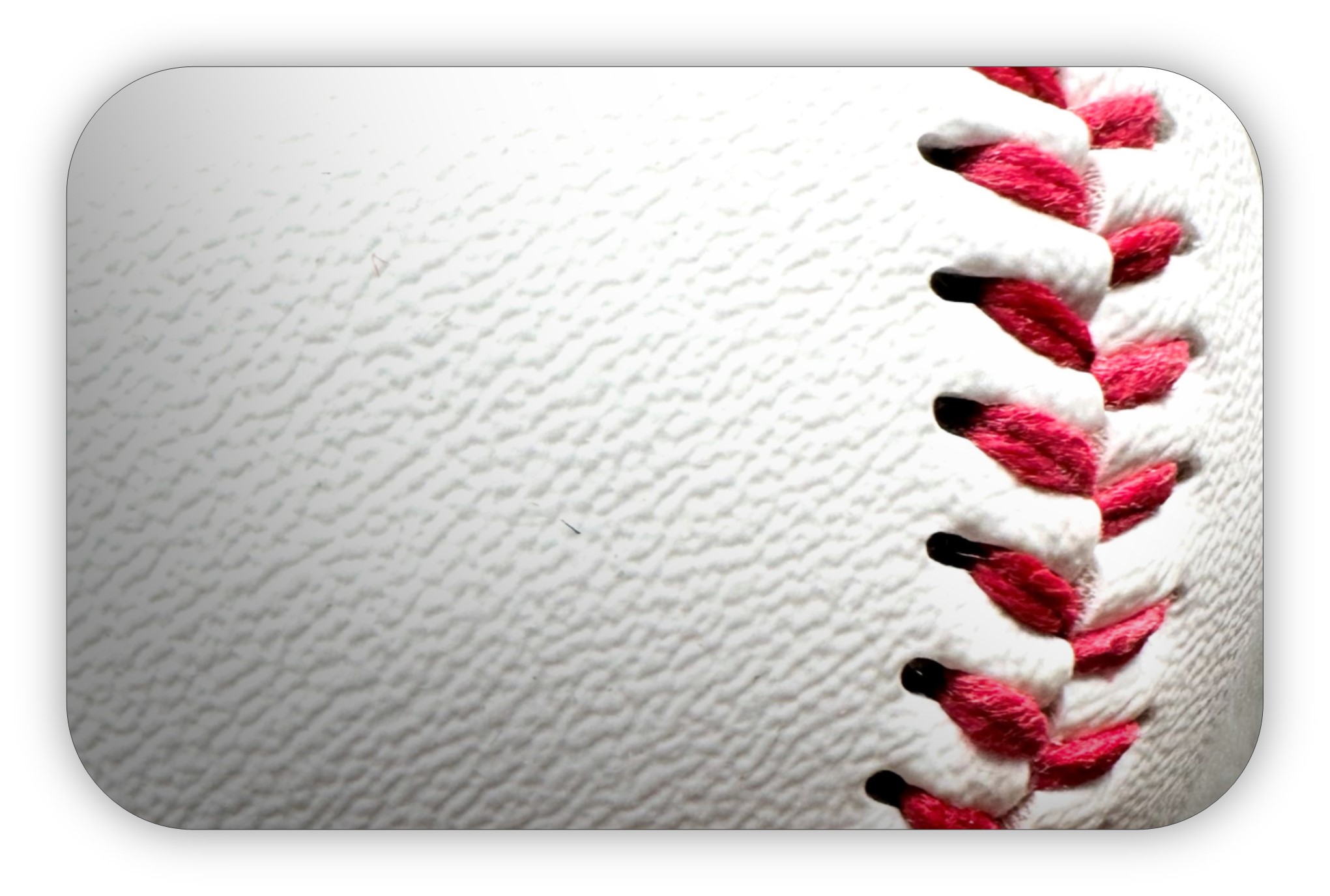 Close-up view of a white baseball with red stitching.