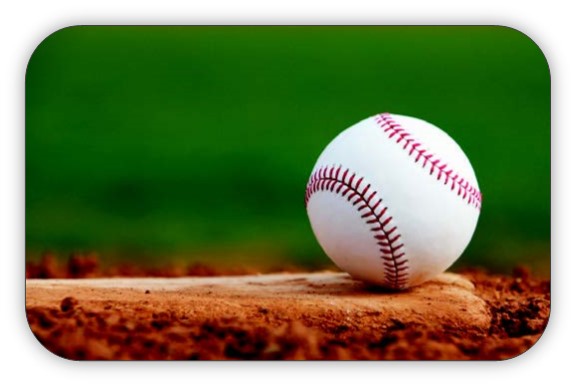 Baseball sitting on the dirt in a baseball field.